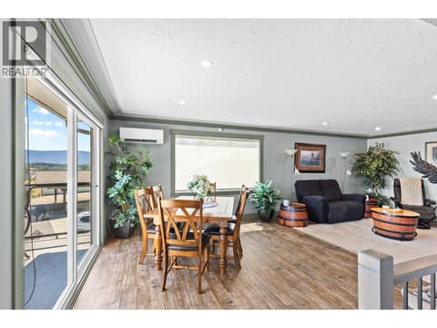 Upstairs dining area open to the living room at 6902 Old Kamloops Road, Swan Lake West, Vernon