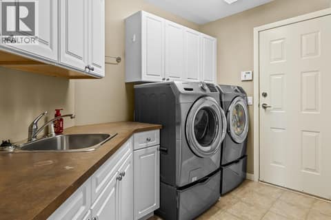 Laundry room on the main floor makes living easy at 3069 Bridlehill Drive, Smith Creek, West Kelowna