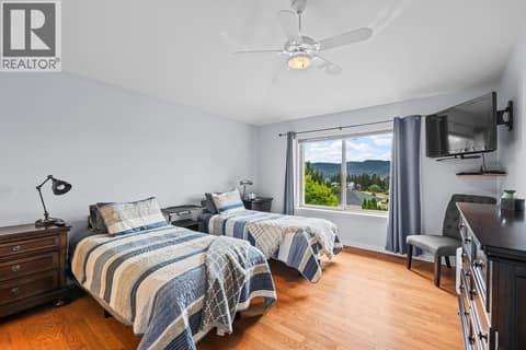 Main floor primary bedroom at 3069 Bridlehill Drive, Smith Creek, West Kelowna