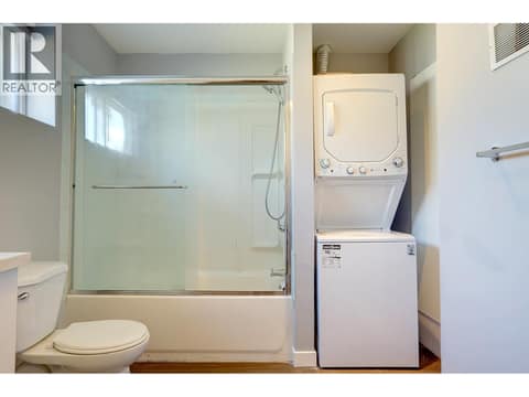 Full bathroom with stacking laundry in basement suite. at 4109 24 Avenue, South Vernon