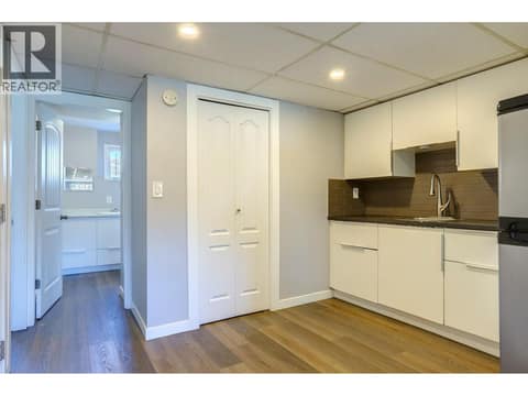 Kitchen towards bathroom in basement suite. at 4109 24 Avenue, South Vernon