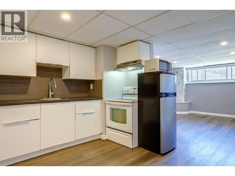 Kitchen towards living room in basement suite. at 4109 24 Avenue, South Vernon