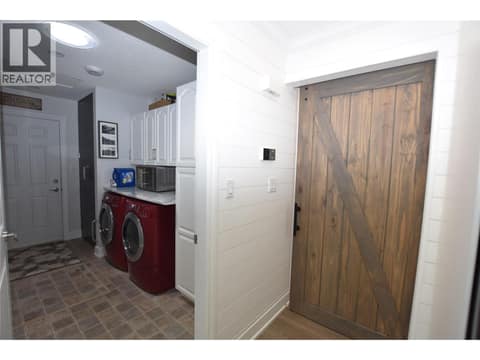 A barn door separates the bedrooms from the main area at 562 Meadowlark Avenue, Okanagan North, Vernon