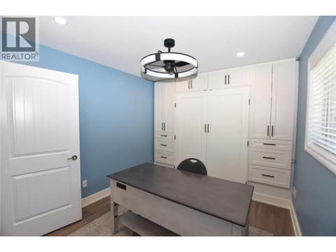 Built in shelving and a space to fit a queen sized bed when the shelving doors are open at 562 Meadowlark Avenue, Okanagan North, Vernon