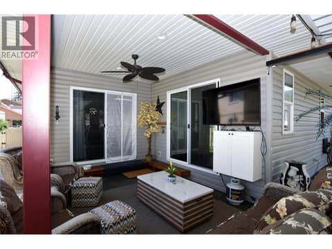 Covered patio with access from the kitchen and the primary at 562 Meadowlark Avenue, Okanagan North, Vernon