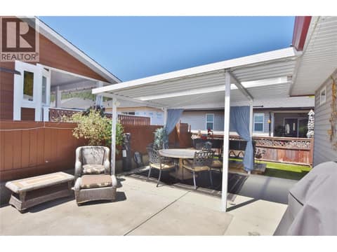 Covered side yard patio at 562 Meadowlark Avenue, Okanagan North, Vernon