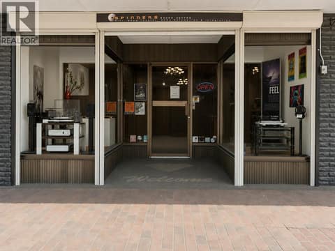 Storefront entrance with display cases and roll down shutters for security at 3107 30 Avenue, City of Vernon