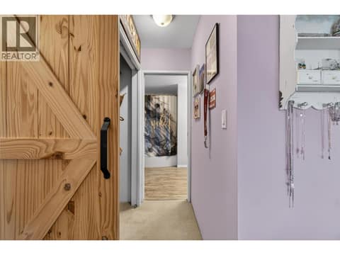 Primary Bedroom closet through to bathroom at 7292 Mountridge Road, North BX, Vernon
