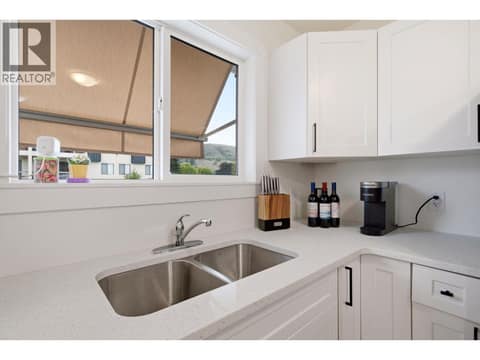 New windows, brand new cabinetry, double sink and quartz countertops at 4004 34 Street Unit# 207 Lot# 15, Alexis Park, Vernon