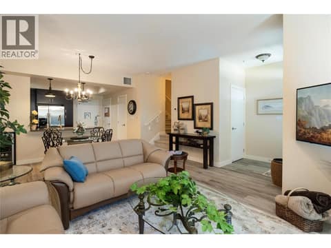Living room view through dining area and into kitchen at 7343 Okanagan Landing Road Unit# 1130, Okanagan Landing, Vernon