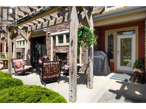 Your patio with outdoor fireplace and courtyard entry at 7343 Okanagan Landing Road Unit# 1130, Okanagan Landing, Vernon