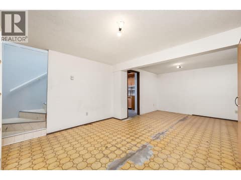 Basement rec room - flooring is now replaced with laminate at 5008 Heritage Drive, Westmount, Vernon