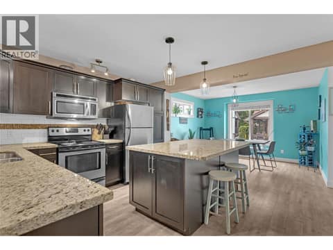 Kitchen with granite countertops and huge island. at 1651 Lynrick Road Unit# 128, Black Mountain, Kelowna