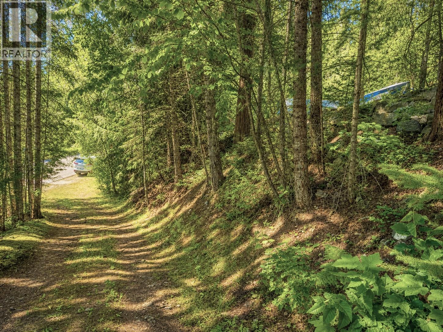 On the right you will see a stone wall that is the market of the parcel boundary at 87 Dolly Varden Road, Ashton Crk/Mabel Lk, Enderby