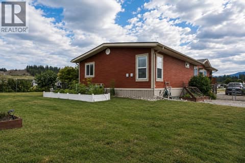 Backyard, far left corner looking at back of home and extra parking on right at 12560 Westside Road Unit# 51, Swan Lake West, Vernon
