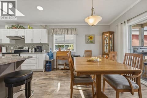 Dining room with access to front porch at 12560 Westside Road Unit# 51, Swan Lake West, Vernon