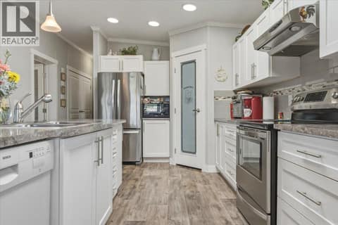 Large pantry and timeless white cabinetry at 12560 Westside Road Unit# 51, Swan Lake West, Vernon