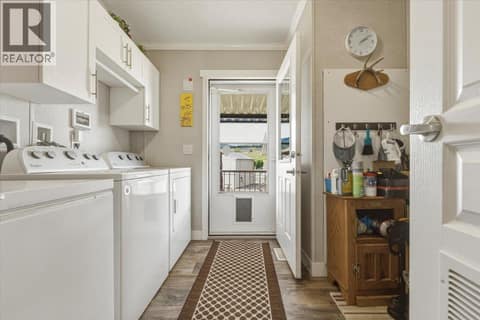 Side door entrance/mud room with laundry at 12560 Westside Road Unit# 51, Swan Lake West, Vernon