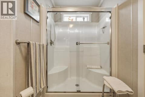 Step-in shower with bench in ensuite at 12560 Westside Road Unit# 51, Swan Lake West, Vernon