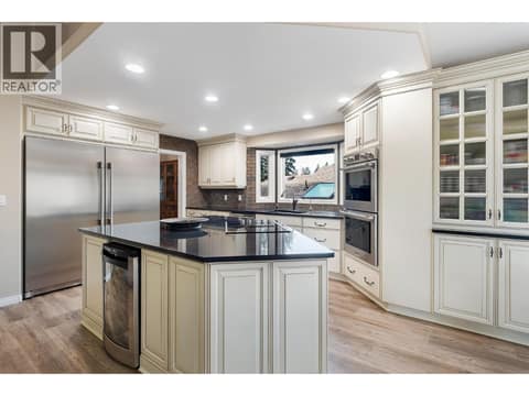 Side by side fridge & freezer, glass stove top & wine fridge at 3907 Gallaghers Circle, South East Kelowna