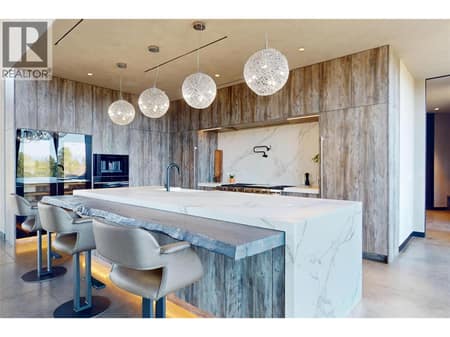 Dekton kitchen island with Fir bar seating area at 4275 Todd Road, South East Kelowna