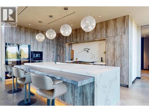 Dekton kitchen island with Fir bar seating area at 4275 Todd Road, South East Kelowna