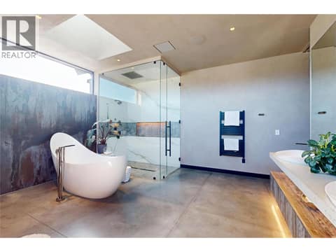 Glass enclosed shower, soaker tub, and towel warmer on auto-timer at 4275 Todd Road, South East Kelowna