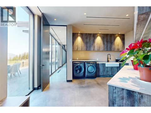 Laundry room wtih ample storage and laundry sink at 4275 Todd Road, South East Kelowna
