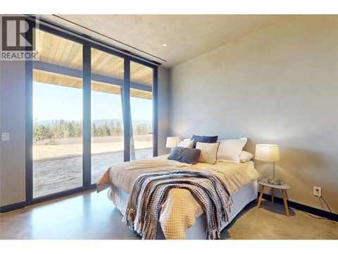 Lower level bedroom #2 with glass doors to outdoor access at 4275 Todd Road, South East Kelowna