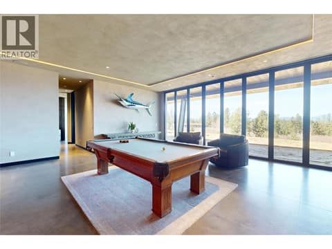 Lower level rec room with 24 ft glass doors to walkout back yard at 4275 Todd Road, South East Kelowna