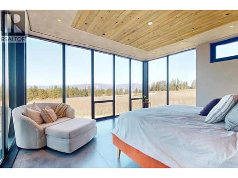 Primary bedroom with floor to ceiling windows at 4275 Todd Road, South East Kelowna