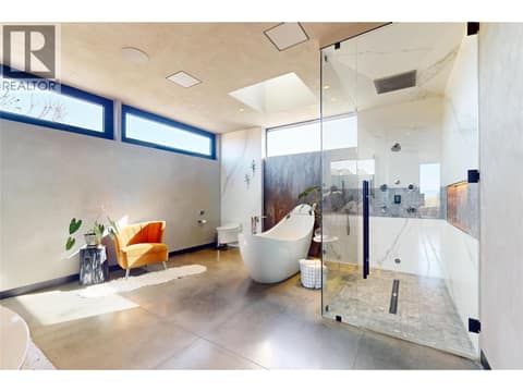 Primary ensuite with motorized open/close windows and skylight at 4275 Todd Road, South East Kelowna