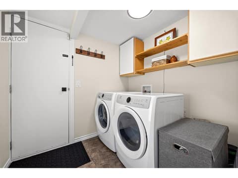A dedicated laundry room with exterior access, built-in storage, and space to stay organized after a day of enjoying the outdoors. at 4075 McClain Road Unit# 22, South East Kelowna