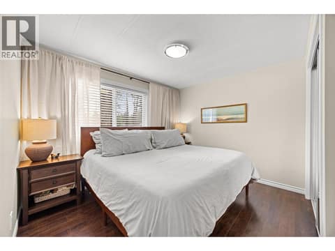 A spacious primary bedroom filled with natural light, complete with generous closet space and calming views of the surrounding trees. at 4075 McClain Road Unit# 22, South East Kelowna