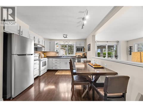Enjoy casual meals and conversation in the spacious dining area, perfectly positioned between the kitchen and living room. at 4075 McClain Road Unit# 22, South East Kelowna