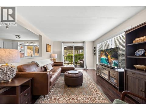 Natural light fills the living room while the sliding glass doors create an effortless connection to your private outdoor retreat. at 4075 McClain Road Unit# 22, South East Kelowna