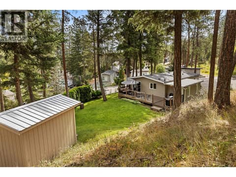 Surrounded by towering pines, this beautifully landscaped property offers exceptional privacy and a peaceful, park-like setting. at 4075 McClain Road Unit# 22, South East Kelowna