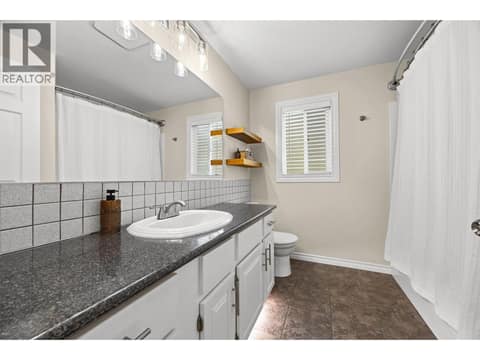 The bright, well-appointed bathroom features an oversized vanity, abundant counter space, and a full tub/shower combination. at 4075 McClain Road Unit# 22, South East Kelowna
