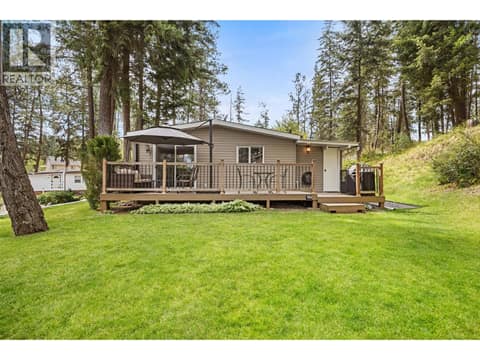 The expansive deck overlooks the beautifully maintained yard, creating the perfect backdrop for entertaining or quiet evenings outdoors. at 4075 McClain Road Unit# 22, South East Kelowna