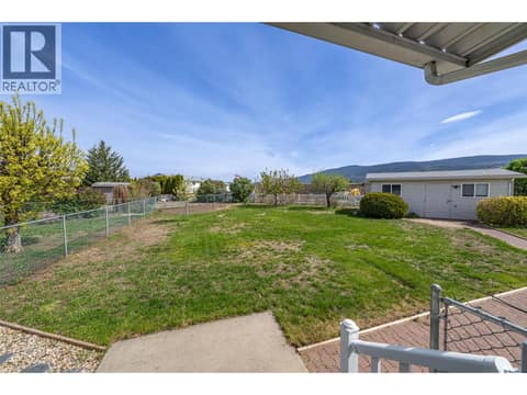 Fenced backyard with  separate dog run Grass is no longer green at 9510 Highway 97 N Unit# 26, Swan Lake West, Vernon