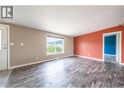 Living room with large window at 9510 Highway 97 N Unit# 26, Swan Lake West, Vernon