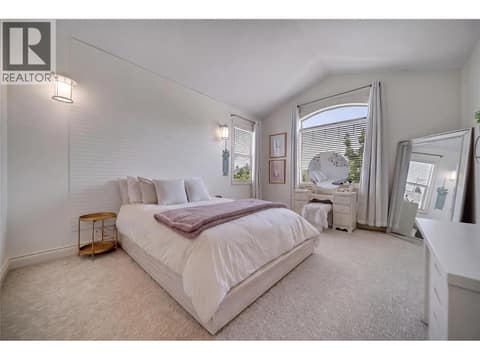 A bright secondary bedroom with comfortable living space, Virtually Staged at 336 Quilchena Drive, Kettle Valley, Kelowna