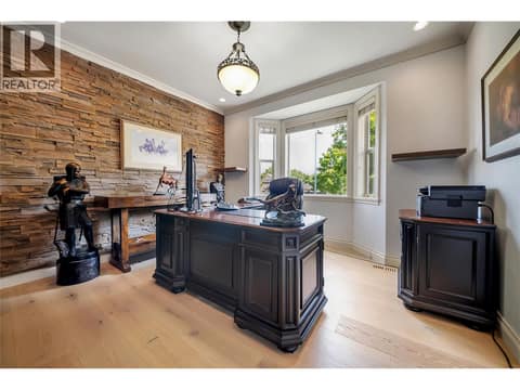 A private home office finished with natural stone accents. Ideal for remote work or a quiet retreat at 336 Quilchena Drive, Kettle Valley, Kelowna