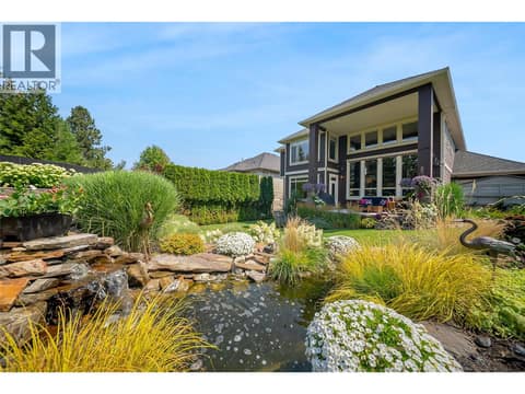 A tranquil water feature adds a resort style feel to the grounds at 336 Quilchena Drive, Kettle Valley, Kelowna