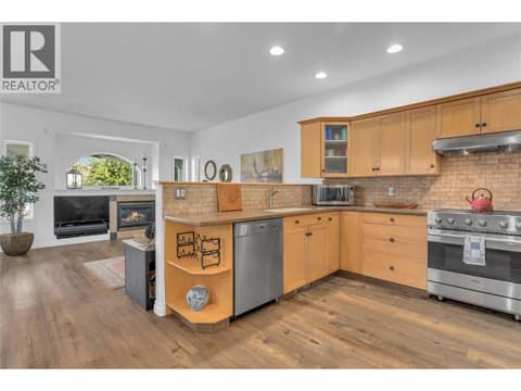 Entetainers kitchen with high end stainless apppliances and Corian countertops. at 430 McCarren Avenue, Kettle Valley, Kelowna