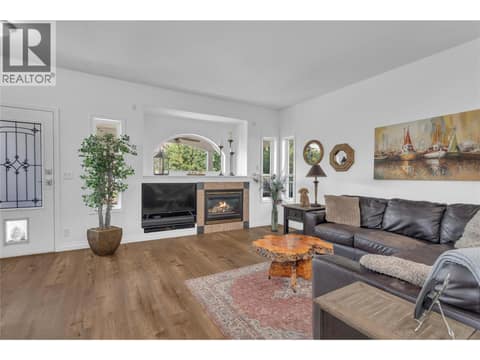 Living room viewed from the dining room/kitchen with the covered deck in the background. at 430 McCarren Avenue, Kettle Valley, Kelowna