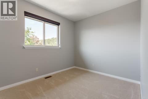 One of the three bedrooms on the top floor at 2538 Copper Ridge Drive, Smith Creek, West Kelowna