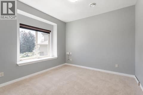 This could be used as an office or a fourth bedroom for the main floor at 2538 Copper Ridge Drive, Smith Creek, West Kelowna