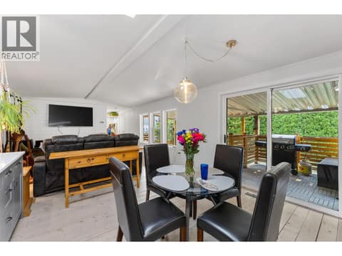 Cozy and bright main living space flows right out to the covered deck. at 610 Katherine Road Unit# 12, West Kelowna Estates