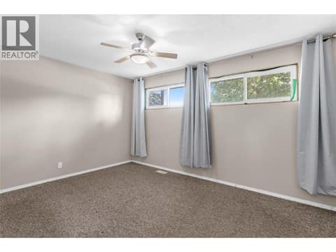First bedroom on the main level at 240 Petch Road, Rutland South, Kelowna